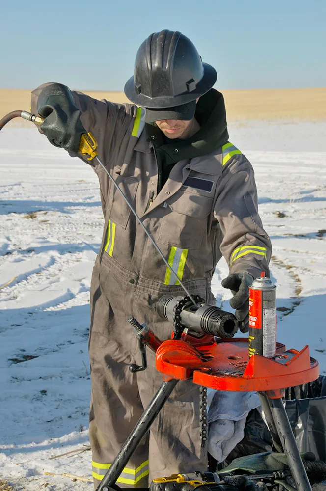 Field technician handling wireline equipment