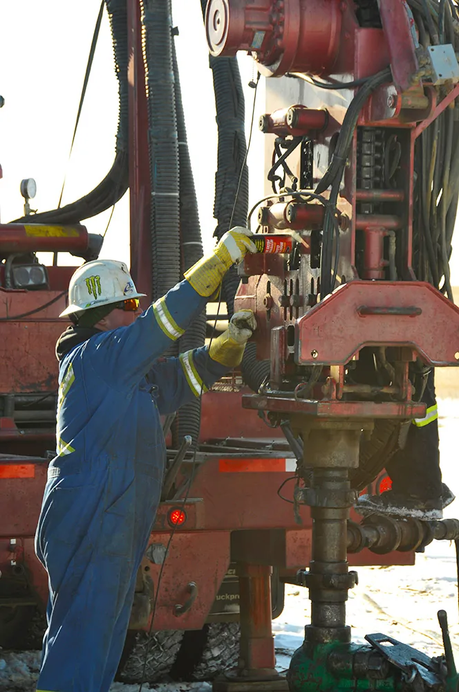 Technician working at wellsite equipment